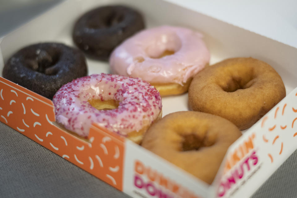 In this Wednesday, Feb. 6, 2019, photo a box of Dunkin' Donuts is displayed in New York. Dunkin' Brands Group Inc. reports financial results Thursday, Feb. 7. (AP Photo/Mark Lennihan)