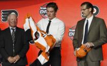 June 23, 2017; Chicago, IL, USA; Nolan Patrick puts on a team jersey after being selected as the number two overall pick to the Philadelphia Flyers in the first round of the 2017 NHL Draft at the United Center. Mandatory Credit: David Banks-USA TODAY Sports