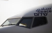 The Arabic, English and Hebrew word for "peace" is seen on the Israeli flag carrier El Al's airliner which will carry Israeli and U.S. delegations to Abu Dhabi for talks meant to put final touches on the normalization deal between the United Arab Emirates and Israel, at Ben Gurion Airport, near Tel Aviv, Israel Monday, Aug. 31, 2020. (Nir Elias/Pool Photo via AP)