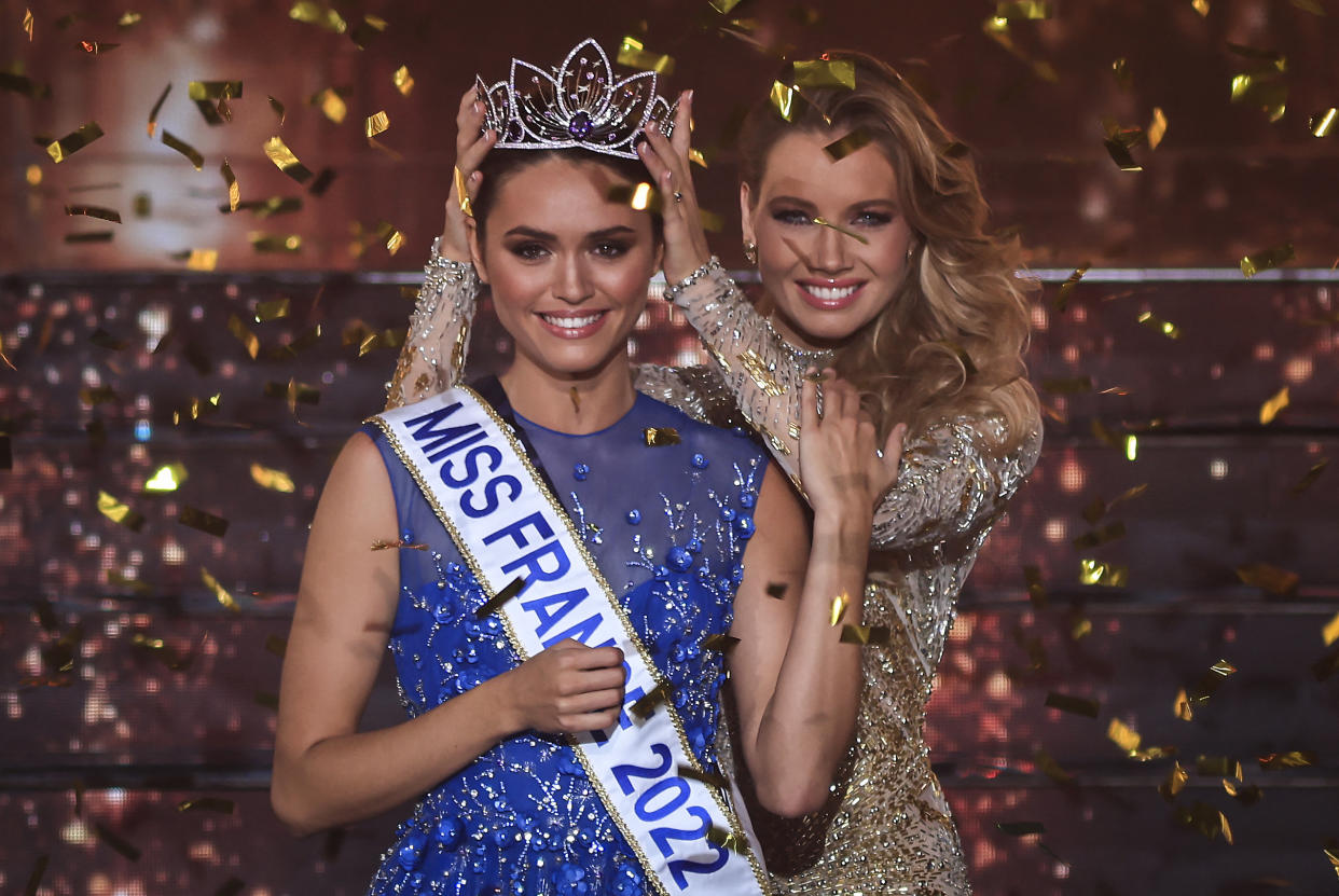 Miss Ile-de-France Diane Leyre is crowned by Miss France 2021 Amandine Petit at the end of the the Miss France 2022 beauty contest in Caen, on December 11, 2021. (Photo by Sameer Al-DOUMY / AFP) (Photo by SAMEER AL-DOUMY/AFP via Getty Images)