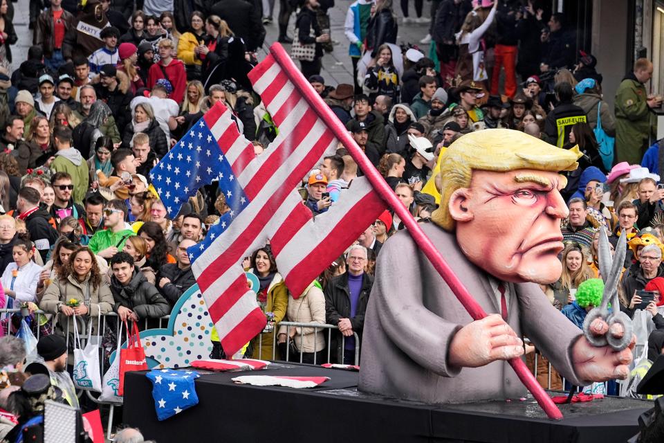 A carnival float depicting Republican presidential candidate and former US President Donald Trump who cut a swastika out of the U.S. national flag appears in the annual Rose Monday (Rosenmontag) Carnival parade in Dusseldorf, Germany, 12 February 2024. Rose Monday is the traditional highlight of the carnival season in many German cities. (Copyright 2024 The Associated Press. All rights reserved)