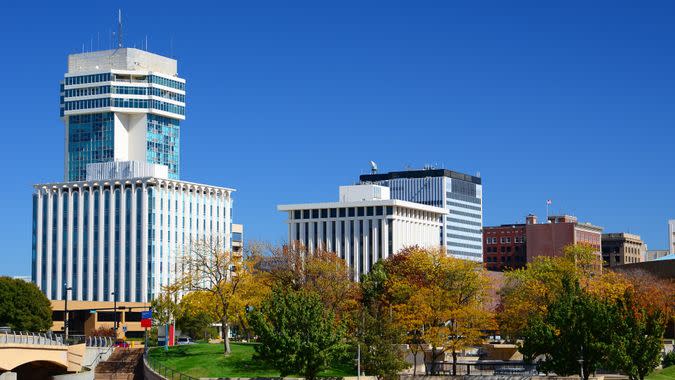 Wichita, Kansas downtown skyline during Autumn, with Autumn trees in the foreground.