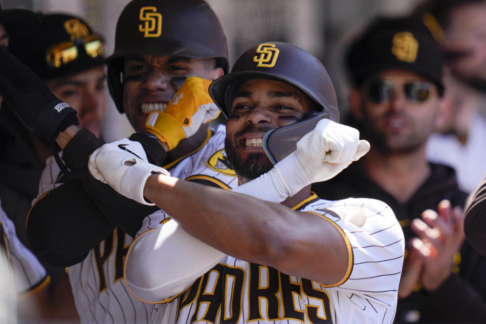 San Diego Padres' Xander Bogaerts, center, celebrates with teammate Juan Soto, left, after hitting a two-run home run during the fifth inning of a baseball game against the Arizona Diamondbacks, Tuesday, April 4, 2023, in San Diego. (AP Photo/Gregory Bull)