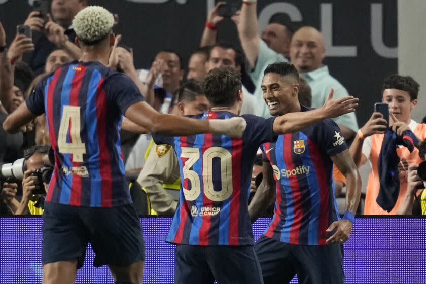 Barcelona's Raphael Dias, right, celebrates after scoring against Real Madrid during the first half of a friendly soccer match Saturday, July 23, 2022, in Las Vegas. (AP Photo/John Locher)