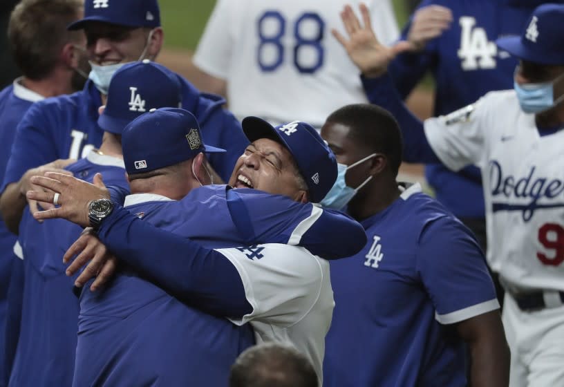 Arlington, Texas, Tuesday, October 27, 2020 Dodgers manager Dave Roberts celebrates with the team after clinching the World Series at Globe Life Field. (Robert Gauthier/ Los Angeles Times)