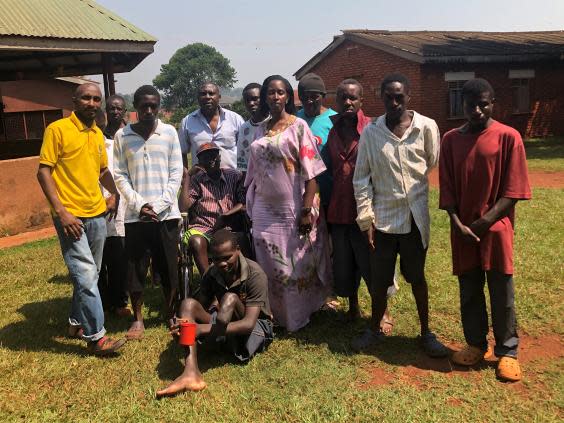 Street Resource founder Merry Ntungyire [C] with residents of the centre in Jinja (Oliver Poole)