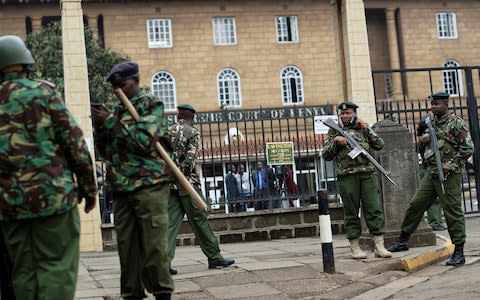 Police guard the Supreme Court building - Credit: Ben Curtis/AP