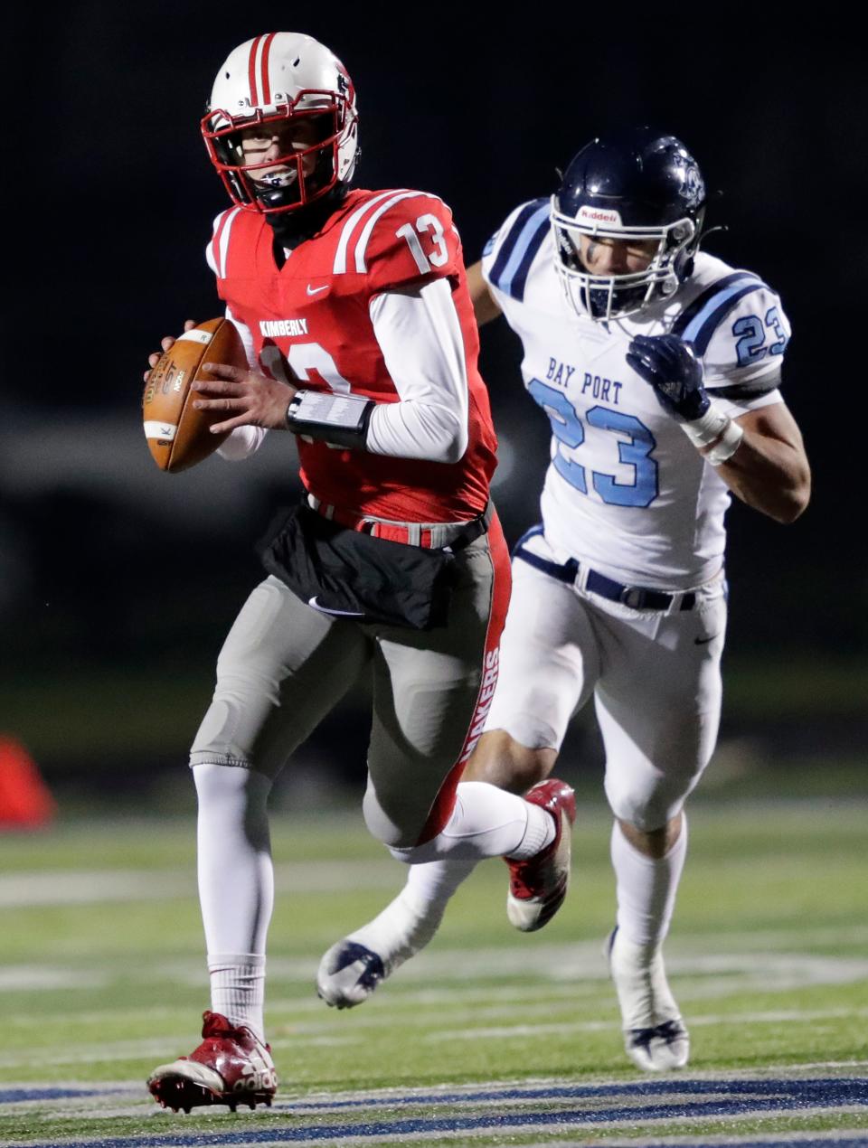 Bay Port's Landon Gauthier (23) pressure Kimberly's Seth Miron (13) during their WIAA Division 1 state semifinal football game in 2022.