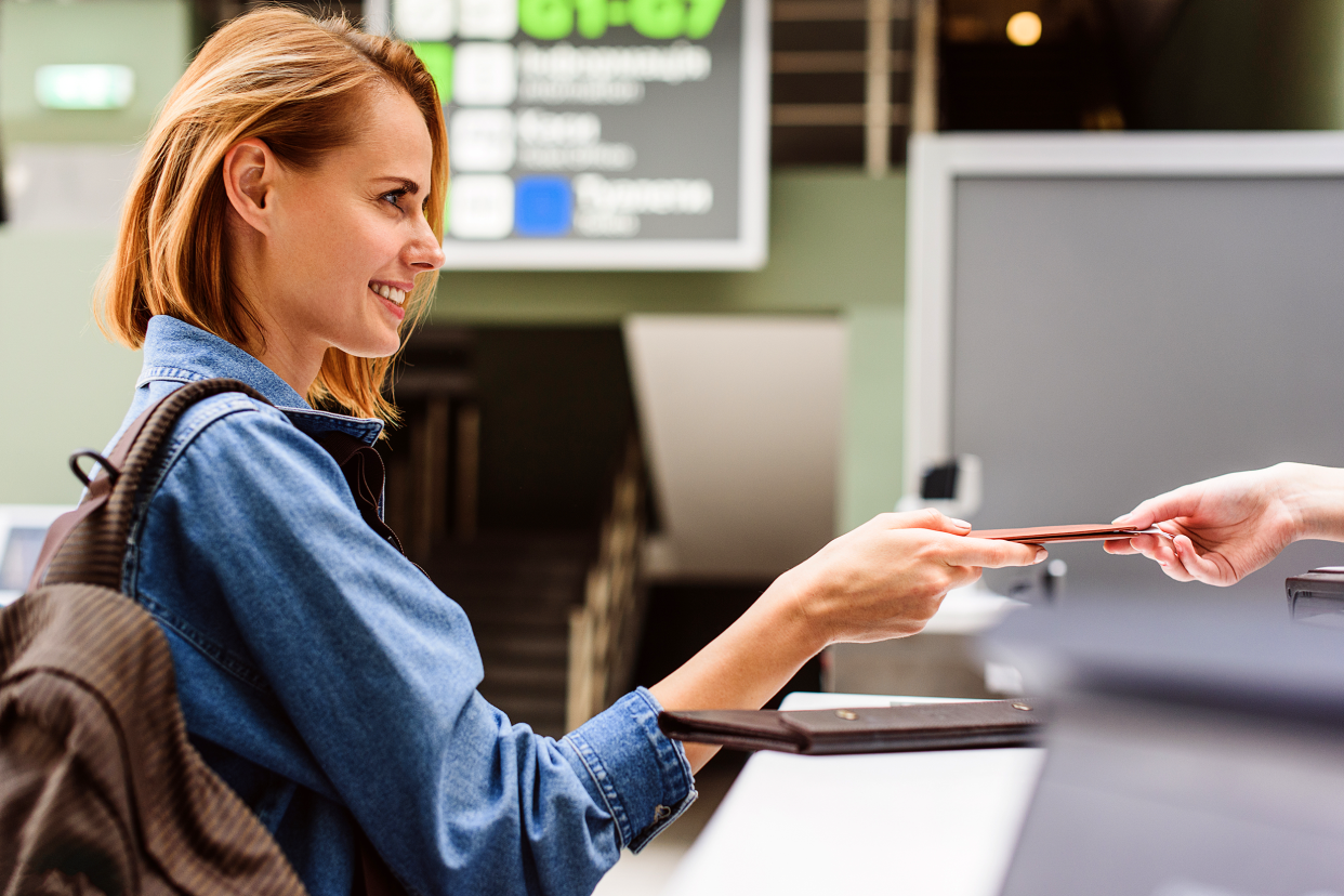 Woman buying an airline ticket at the airport