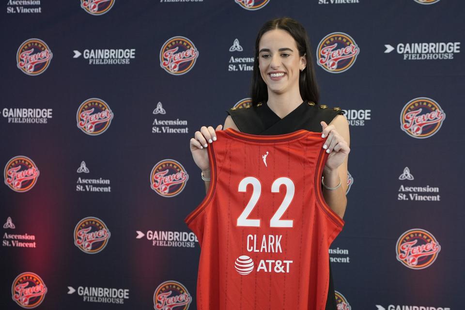 Indiana Fever's Caitlin Clark holds her jersey following a WNBA basketball news conference, Wednesday, April 17, 2024, in Indianapolis. (AP Photo/Darron Cummings)