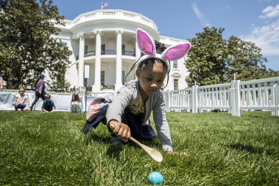 FILE - In this April 22, 2019 file photo, Chloebella Frazier, 4, of Washington, takes part in the annual White House Easter Egg Roll on the South Lawn of the White House in Washington. (AP Photo/Andrew Harnik)