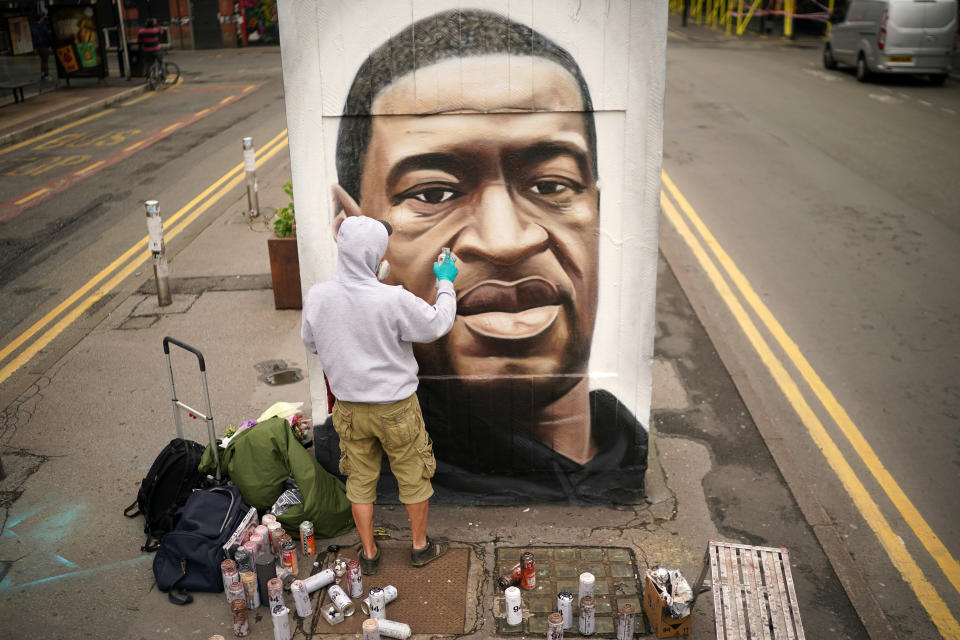 MANCHESTER, UNITED KINGDOM - JUNE 03: Graffiti artist Akse spray paints a mural of George Floyd in Manchester's northern quarter on June 03, 2020 in Manchester, United Kingdom. The death of an African-American man, George Floyd, while in the custody of Minneapolis police has sparked protests across the United States, as well as demonstrations of solidarity in many countries around the world. (Photo by Christopher Furlong/Getty Images)