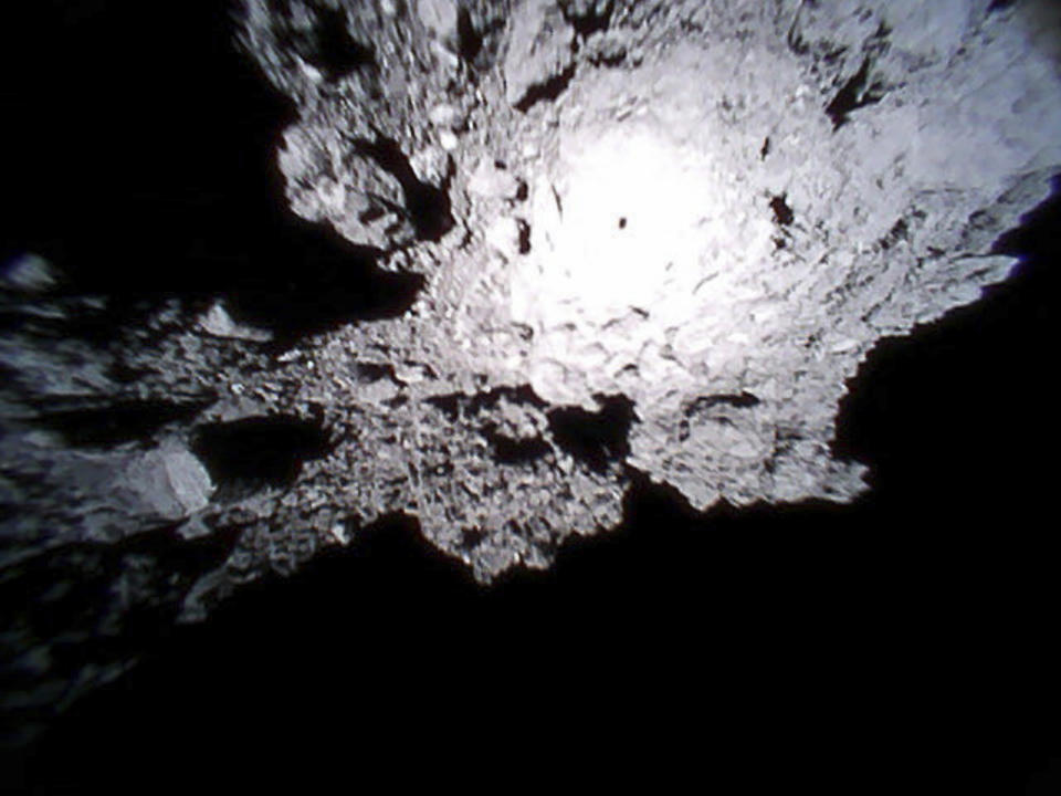 This Oct. 26, 2018, image captured by Rover-1A, and provided by the Japan Aerospace Exploration Agency (JAXA) on Thursday, Dec. 13, 2018, shows the surface of asteroid Ryugu. Japan's space agency JAXA said Thursday, Dec. 13, 2018, more than 200 photos taken by two small rovers on the asteroid show no signs of a smooth area for the planned touchdown of a spacecraft early next year. (JAXA via AP)