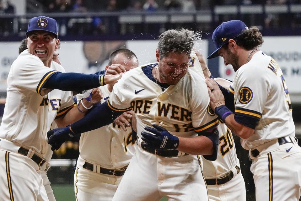 Milwaukee Brewers' Hunter Renfroe is congratulated after hitting a walk-off single during the 10th inning of a baseball game against the Arizona Diamondbacks Monday, Oct. 3, 2022, in Milwaukee. The Brewers won 6-5. (AP Photo/Morry Gash)