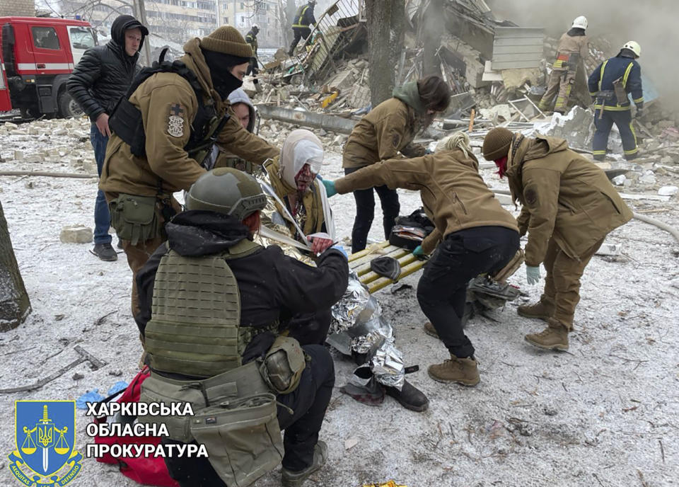 In this photo provided by Kharkiv Regional Prosecutor's Office, medical staff carry a local resident injured as a result of a Russian missile attack in Kharkiv, Ukraine, Tuesday, Jan. 23, 2024. (Kharkiv Regional Prosecutor's Office/ via AP)