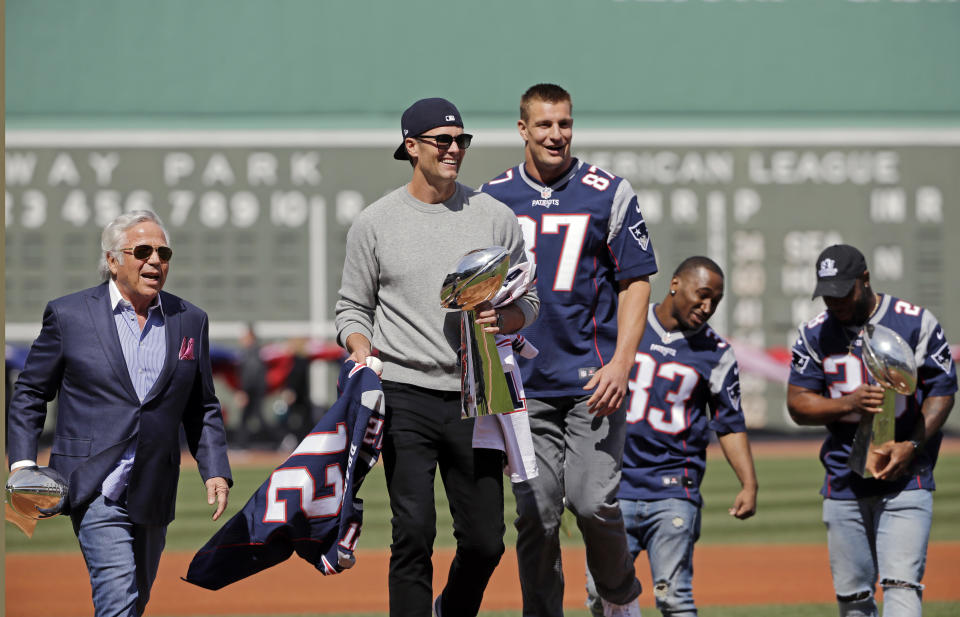 Patriots QB Tom Brady, center, teammates and owner Robert Kraft brought the Lombardi Trophy to Fenway Park last year. A member of the Red Sox said on Thursday following Brady’s workout methods has helped him. (AP)