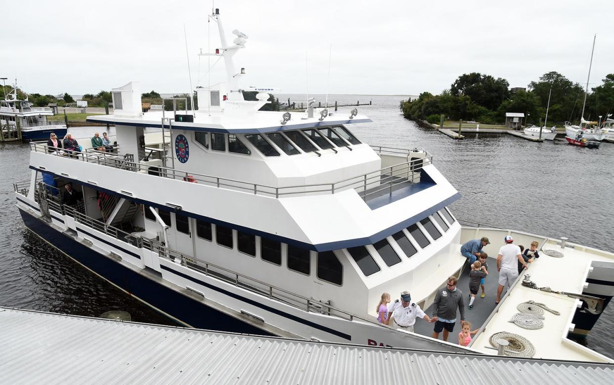 Vacationers evacuate Bald Head Island via the Deep Point Marina ferry. The village of Bald Head island will seek $52 million in financing to purchase the island's ferry system.