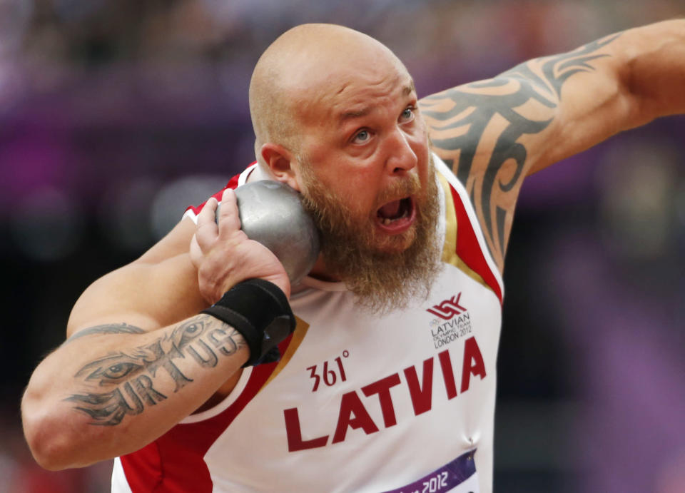 Latvia's Maris Urtans makes an attempt in the men's Shot Put qualification during the athletics in the Olympic Stadium at the 2012 Summer Olympics, London, Friday, Aug. 3, 2012. (AP Photo/Matt Dunham)