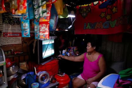 A resident watches television inside a room at Vitas Tenement, a government housing building, in Tondo, Manila, Philippines, May 8, 2018. REUTERS/Erik De Castro