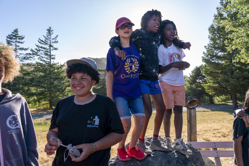Campers from left, Raphael Spencer, 13, of San Francisco, Emmeline Agiurre, 11, of Fremont, Calif., Overton Butler, 11, of Washington, D.C., and Obi Blair, 8, of Los Angeles, sing during a peace circle at Camp Be’chol Lashon, a sleepaway camp for Jewish children of color, July 29, 2023, in Petaluma, Calif., at Walker Creek Ranch. L. Lee Butler’s son Overton attends a Jewish day school in the nation’s capital. Butler is white and Jewish, while his sons are Black, “While I can provide racial mirrors and role models for them,” says Butler, “they’re not Jewish role models. I want them to have strong identities, not just with Jewishness or Blackness, but with Black Jewishness.” (AP Photo/Jacquelyn Martin)