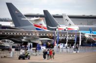 People walk past aircrafts on static display, at the eve of the opening of the 53rd International Paris Air Show at Le Bourget Airport near Paris