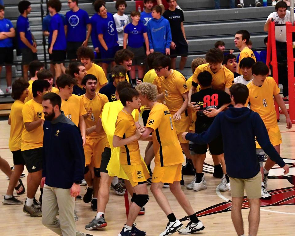The Moeller Crusaders celebrate after winning the Division I  region two volleyball championship topping St. Xavier 3 sets to 2 at the OHSBVA South Region championships, May 28, 2022.