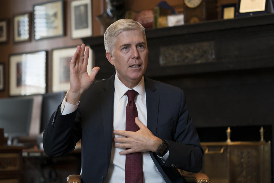 Associate Justice Neil Gorsuch, President Donald Trump's first appointee to the high court, speaks to The Associated Press about events that have influenced his life and the loss of civility in public discourse, in his chambers at the Supreme Court in Washington, Wednesday, Sept. 4, 2019. Gorsuch has written a new book on the importance of civics and civility, and a defense of his preferred originalism method of interpreting laws and the Constitution. (AP Photo/J. Scott Applewhite)