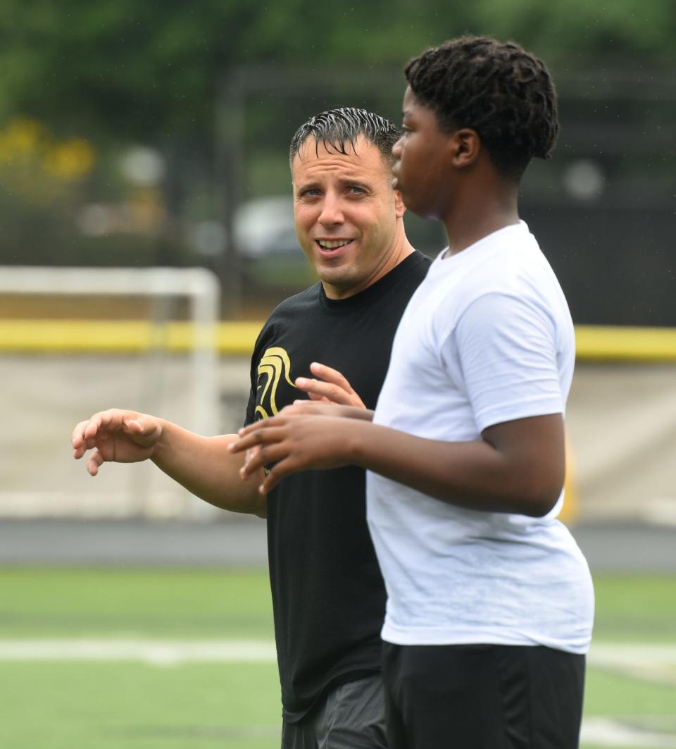 The 2022 TNT football camp opens at Paramus Catholic on July 18, 2022. Paramus Catholic head football coach Greg Russo talks with a player.