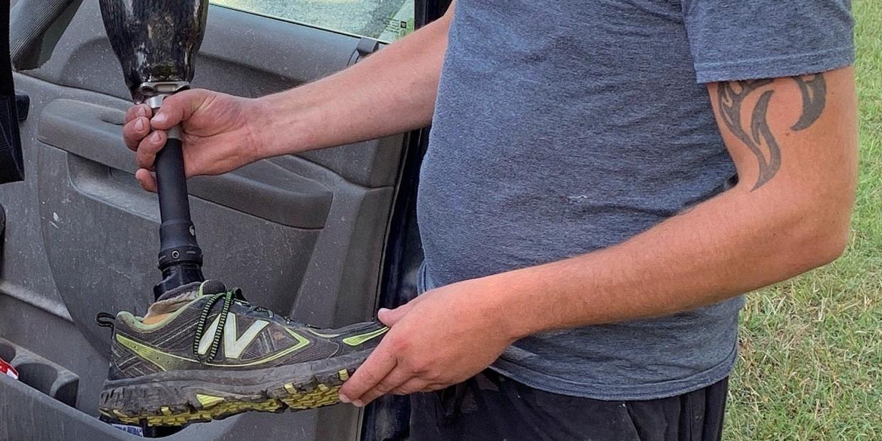 Farmer Joe Marszalkowski holds a prosthetic leg, Monday, July 27, 2020, that he found Sunday in a soybean field on his farm in West Addison, Vt. The leg was lost by double amputee Chris Marckres while skydiving on Saturday.