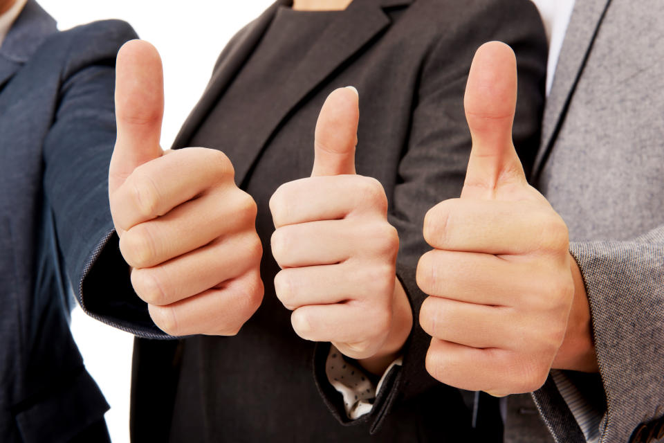 Three people giving a thumbs up sign.