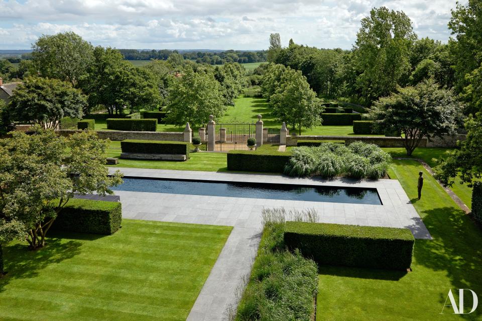 An Antony Gormley sculpture faces the pool, which is framed with slate. landscape design by Christopher Bradley-Hole.