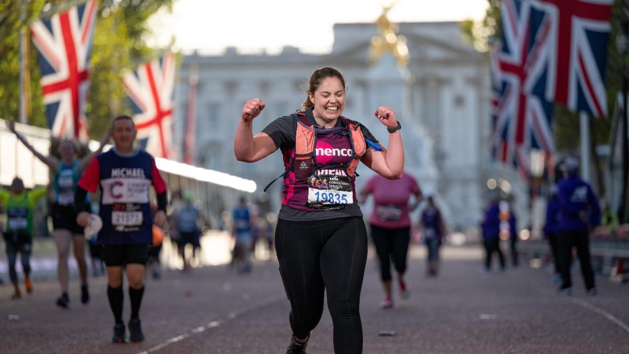  A runner celebrates as they cross the finish line on The Mall, The TCS London Marathon on Sunday 2nd October 2022. 
