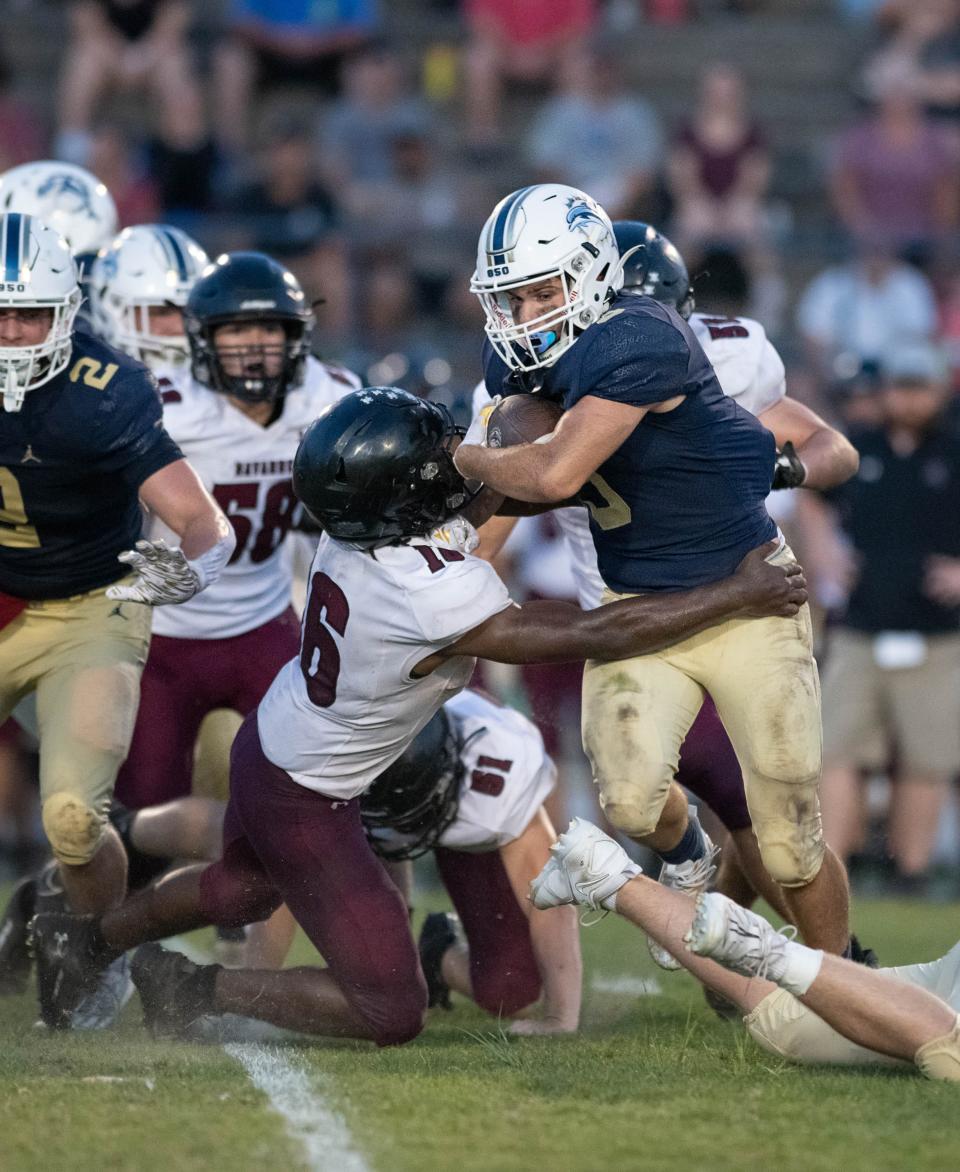 Evan Hernandez (3) carries the ball during the Navarre vs Gulf Breeze spring football game at Gulf Breeze High School on Friday, May 19, 2023.