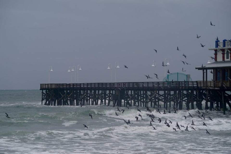 Waves churned up by Hurricane Idalia pound the Daytona Beach boardwalk on Wednesday, Aug. 30, 2023.
