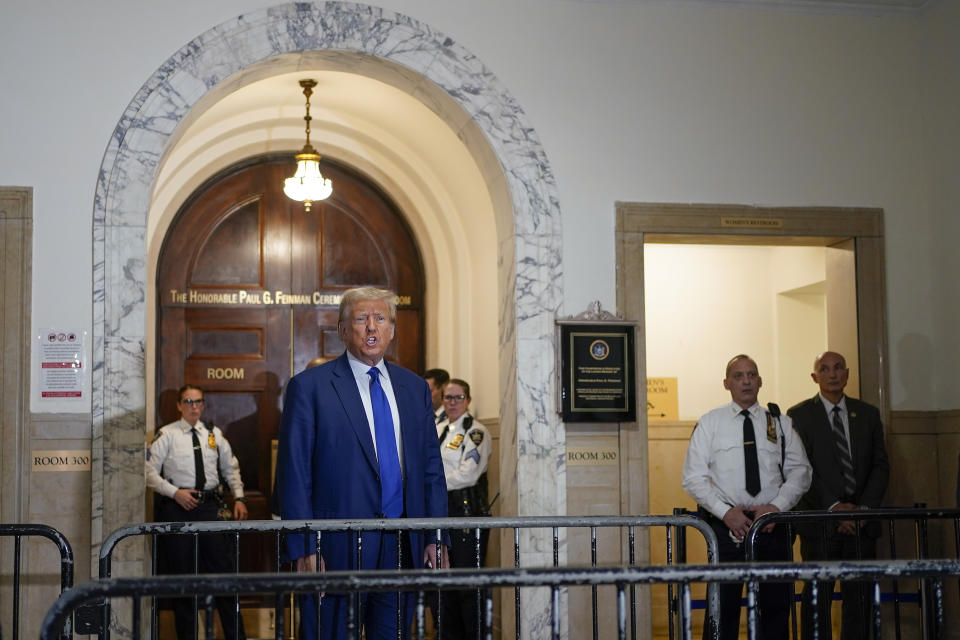 Former President Donald Trump speaks before entering the courtroom for the continuation of his civil business fraud trial at New York Supreme Court, Wednesday, Oct. 25, 2023, in New York. (AP Photo/Seth Wenig)