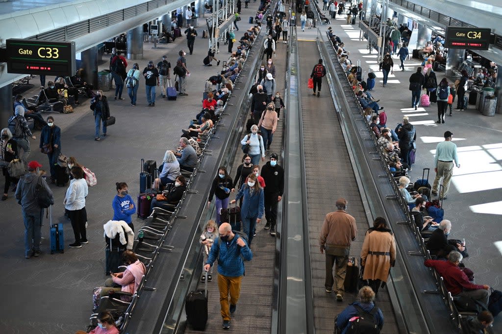 Travellers wear masks at Denver airport  (AFP via Getty Images)