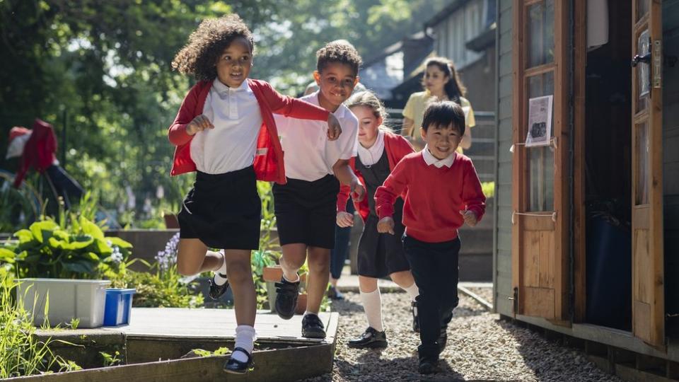 Stock image of school children running