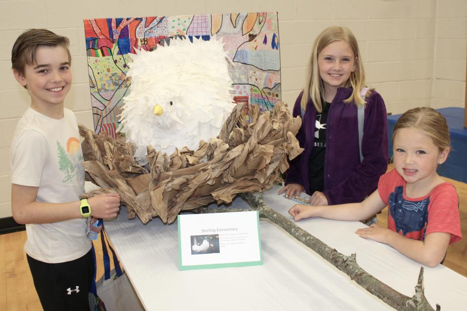 Sterling Elementary School students Charlie Smart, 10 (left), Harper Swiontoniowski, 9, and Finley Swiontoniowski, 5, participated in the “Wings of Change” school project and helped build this white dove out of coffee filters and recycled bags. Provided by Kennedy Bowling