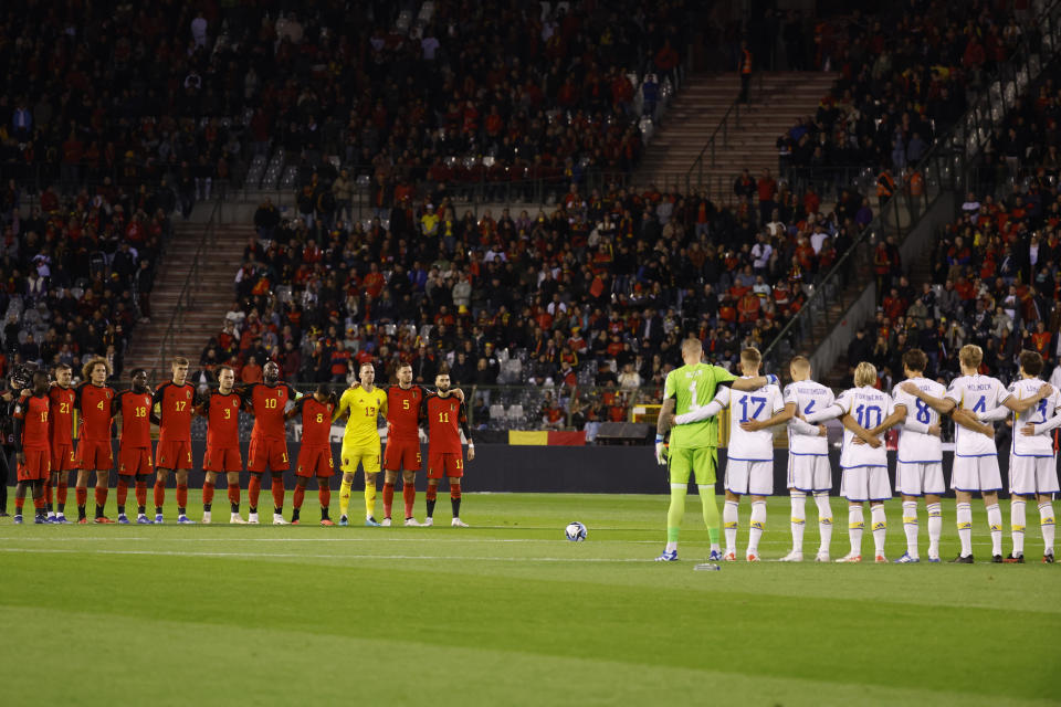 Squads observe a moment of silence for victims of recent violence in the Middle East before the Euro 2024 group F qualifying soccer match between Belgium and Sweden at the King Baudouin Stadium in Brussels, Monday, Oct. 16, 2023. (AP Photo/Geert Vanden Wijngaert)