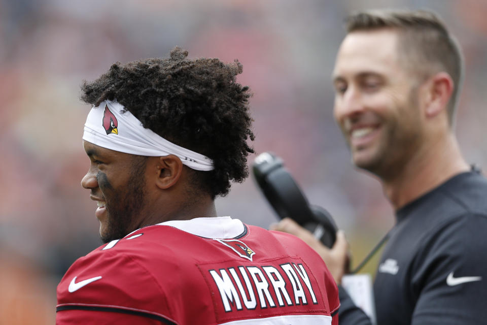 Arizona Cardinals quarterback Kyler Murray, left, speaks with head coach Kliff Kingsbury, right, in the first half of an NFL football game against the Cincinnati Bengals, Sunday, Oct. 6, 2019, in Cincinnati. (AP Photo/Gary Landers)