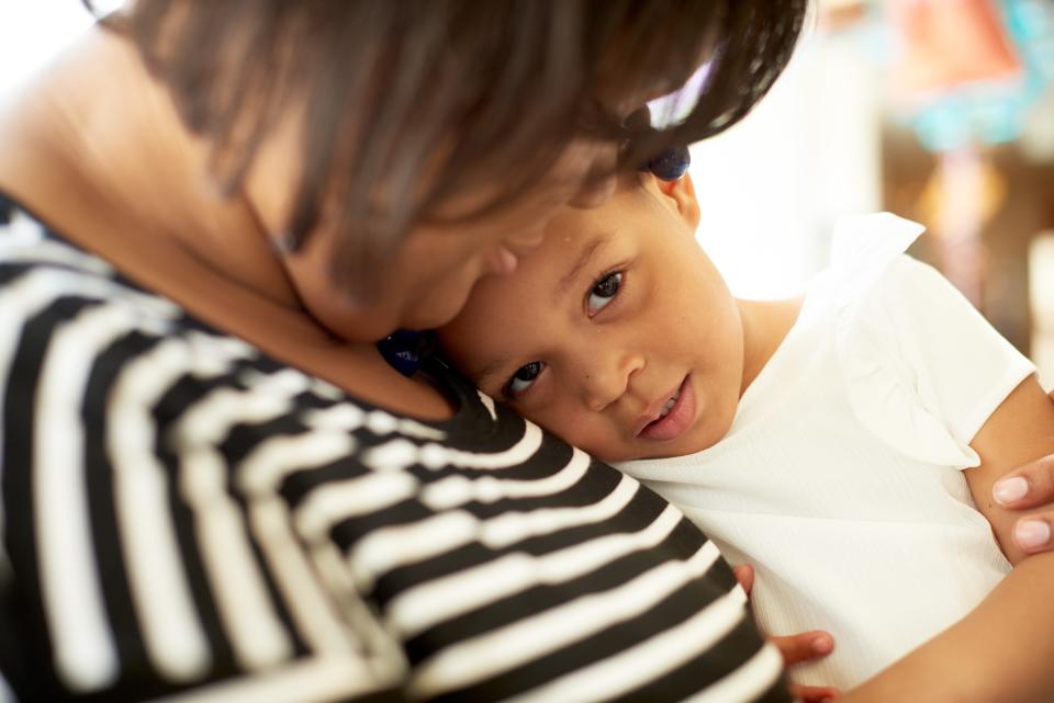 A mother holds her daughter, who had a ventricular assist device (VAD) implanted in 2017, when a bad RSV infection nearly took her life.