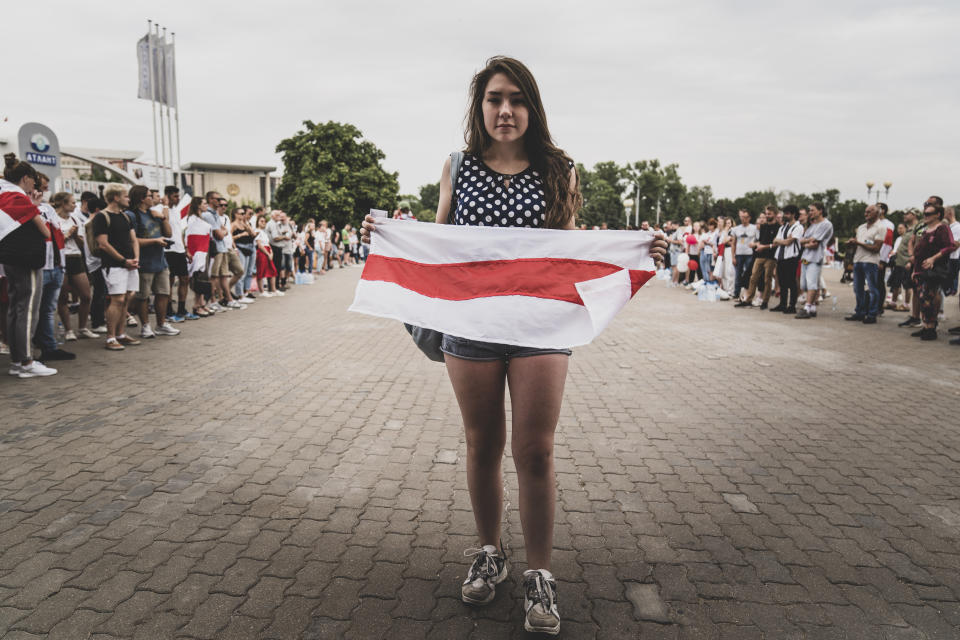 Viktoria Bogutenko, an employee at the refrigerator factory "Atlant", poses for a photo during an opposition rally in front of the factory in Minsk, Belarus, Tuesday, Aug. 18, 2020. "I am against the current authorities, but I am not for this strike," she said. Her voice choked with emotion as she described the importance of keeping the conveyor belts moving, for the sake of salaries and "ordinary people" like her. (AP Photo/Evgeniy Maloletka)