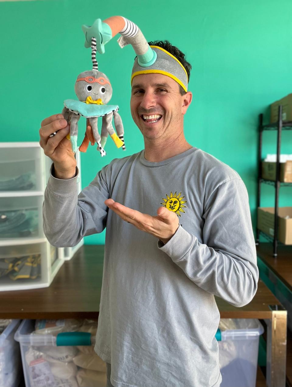 Stewart Gold, co-founder of Dingle Dangle, poses with the innovative, multi-use interaction and distraction baby product he helped design.