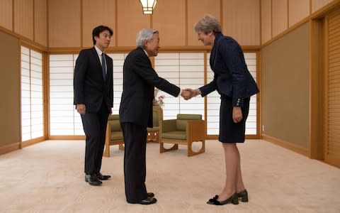 Britain's Prime Minister Theresa May (right) is greeted by Emperor Akihito of Japan at the Royal Palace in Tokyo, on the third day of her visit to Japan - Credit: Carl Court/PA