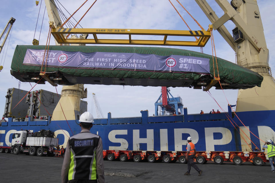 Workers unload a part of Chinese-made high-speed passenger train from a cargo ship at Tanjung Priok Port in Jakarta, Indonesia, Friday, Sept. 2, 2022. The first high-speed electric train which is prepared for the Jakarta-Bandung High-Speed Railway arrived in the capital city on Friday.(AP Photo/Dita Alangkara)