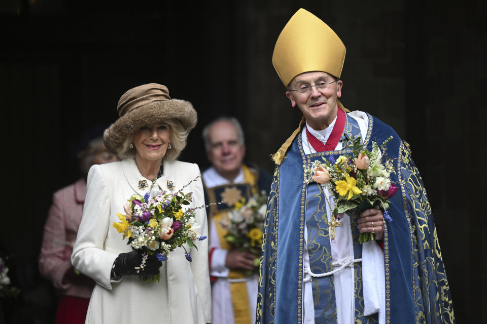 Britain's Queen Camilla leaves the Royal Maundy Service with Bishop of Worcester Cathedral, The Right Reverend Dr John Inge where she distributed the Maundy money to 75 men and 75 women, mirroring the age of the monarch, in Worcester Cathedral, in Worcester, England, Thursday, March 28, 2024. Maundy Thursday is the Christian holy day falling on the Thursday before Easter. The monarch commemorates Maundy by offering 'alms' to senior citizens. Each recipient receives two purses, one red and one white. (Justin Tallis, Pool Photo via AP)