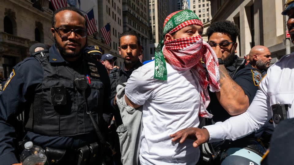 Police lead a man in handcuffs away from a protest near the New York Stock Exchange. - Spencer Platt/Getty Images