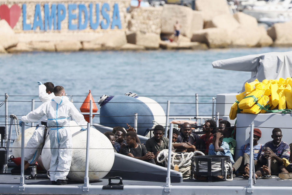 Rescued migrants sit in a boat of the Italian Finance Police before disembarking at the port of the Sicilian island of Lampedusa, southern Italy, Monday, Sept. 18, 2023. The Italian Cabinet met Monday to adopt new measures to crack down on migration after the southern island of Lampedusa was again overwhelmed by a wave of arrivals from Tunisia and the migration issue again took center stage in Europe with talk of a naval blockade. (Cecilia Fabiano/LaPresse via AP)