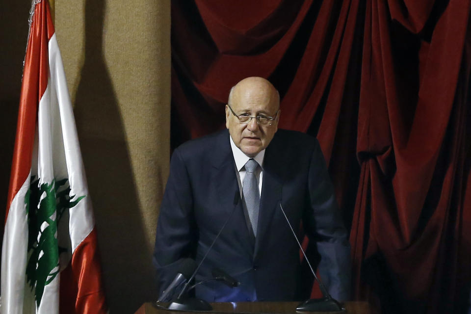 Lebanese Prime Minister Najib Mikati speaks during a parliament session to confirm Lebanon's new government at a Beirut theater known as the UNESCO palace so that parliament members could observe social distancing measures imposed over the coronavirus pandemic, Lebanon, Monday, Sept. 20, 2021. A power outage and a broken generator briefly delayed the start of the parliament session for some 40 minutes before electricity came back on. (AP Photo/Bilal Hussein)