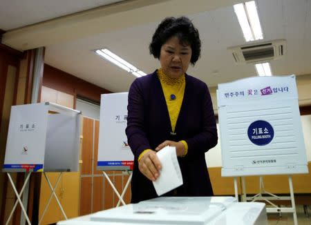 A woman casts her vote at a polling station during the presidential elections in Seoul, South Korea May 9, 2017. REUTERS/Kim Kyung-hoon